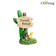 Miniature “Small Forest” resin sign ornament with green cactus-style plants, wooden signboard, yellow rabbit figurine, and grassy base for aquarium and fairy garden decoration.