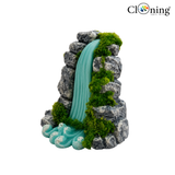 Decorative rock formation with a artificial waterfall on a white background