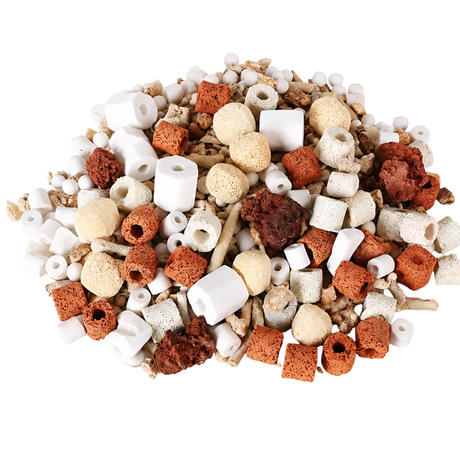 Assorted aquarium gravel and decorations on a white background