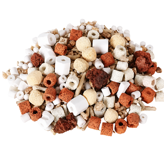 Assorted aquarium gravel and decorations on a white background